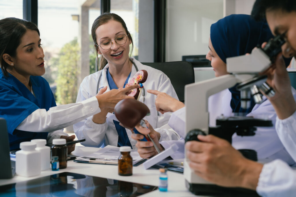 Medical, meeting and laptop for team in office in discussion, brainstorming and planning. Doctor, nurse and computer on desk, teamwork or workshop for data analytics.