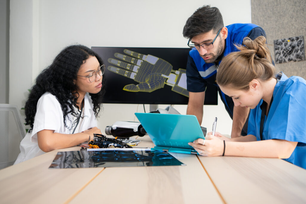 Engineers, doctors and physical therapists brainstorm ideas to design a robot with arm and hand organs, To be utilized for additional testing on patients.